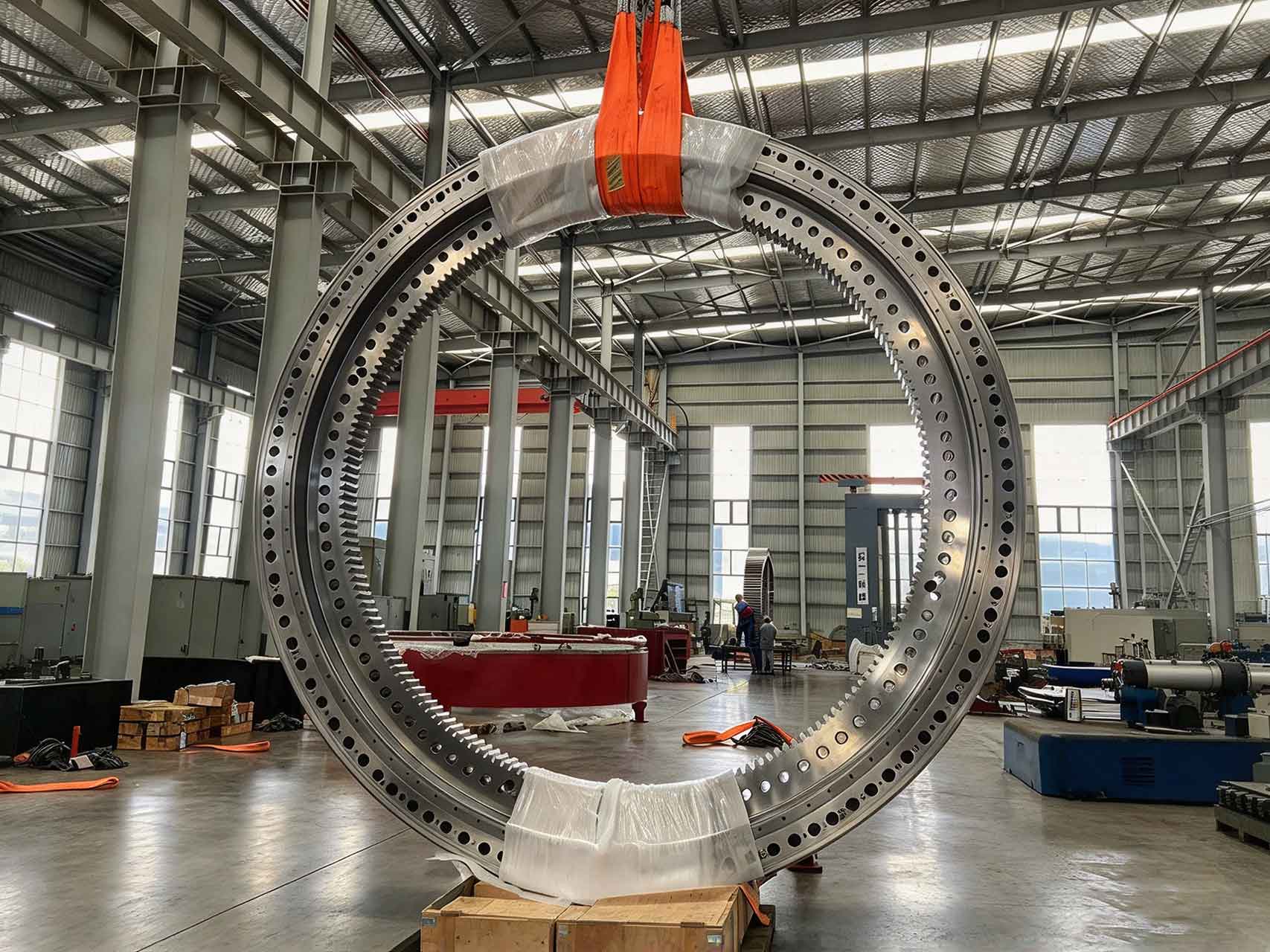 A large slewing ring gear showing multiple, evenly spaced grease fitting locations for proper lubrication.